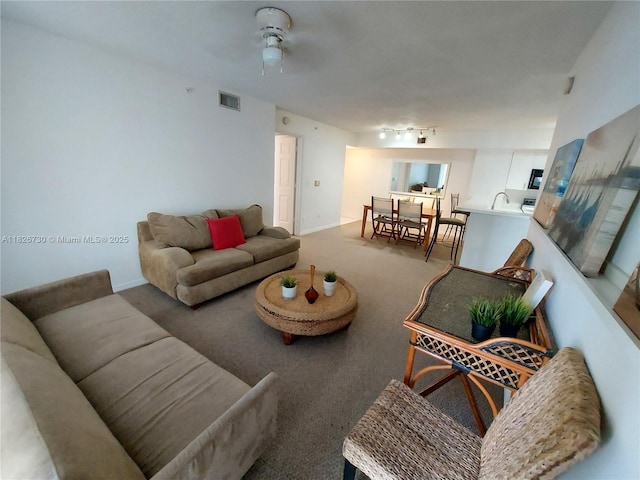 2640 S University Dr Unit 125, Davie, FL 33328 - carpeted living area featuring a ceiling fan and a sink