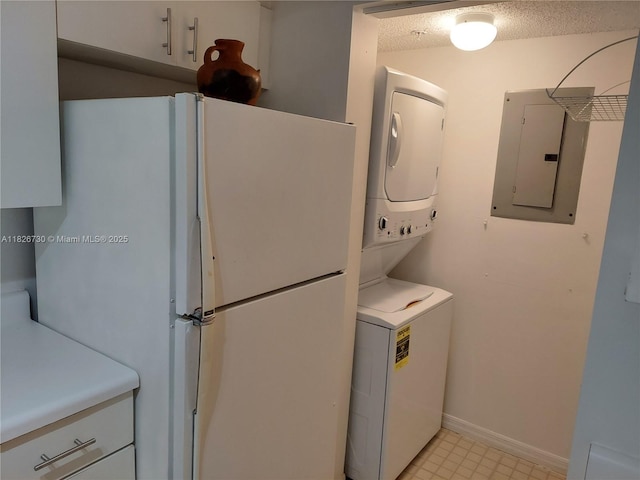 2640 S University Dr Unit 125, Davie, FL 33328 - laundry area featuring stacked washer / dryer, electric panel, and a textured ceiling