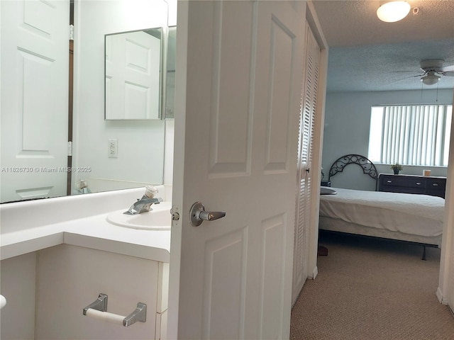 2640 S University Dr Unit 125, Davie, FL 33328 - ensuite bathroom featuring vanity, ceiling fan, a textured ceiling, and a closet
