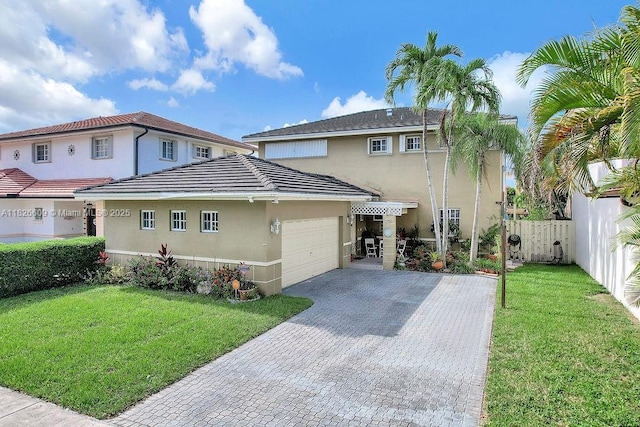 14783 SW 143rd Ter, Miami, FL 33196 - view of front of home featuring stucco siding, a garage, and decorative driveway