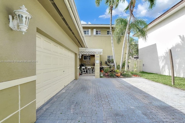 14783 SW 143rd Ter, Miami, FL 33196 - exterior space featuring stucco siding, decorative driveway, and a garage