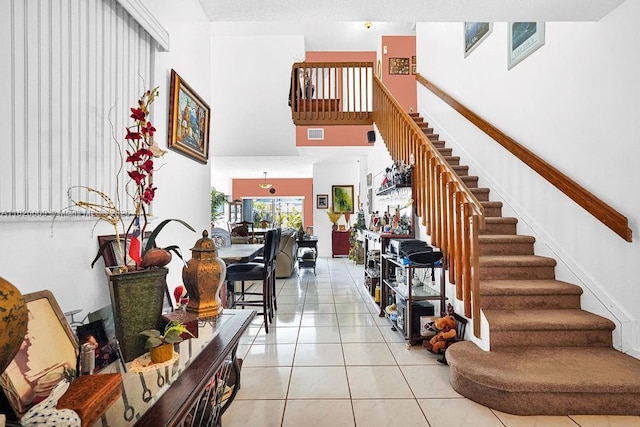 14783 SW 143rd Ter, Miami, FL 33196 - staircase featuring tile patterned floors and a high ceiling