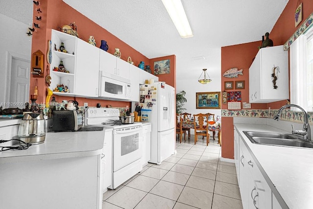 14783 SW 143rd Ter, Miami, FL 33196 - kitchen with white appliances, open shelves, light countertops, white cabinetry, and light tile patterned floors