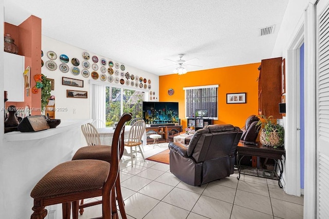 14783 SW 143rd Ter, Miami, FL 33196 - living room with a ceiling fan, a textured ceiling, and light tile patterned flooring