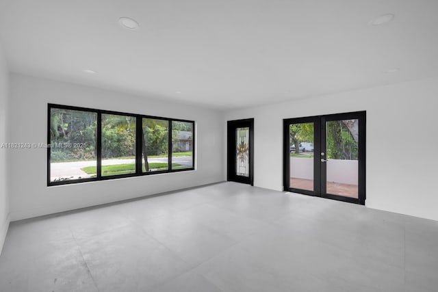 220 NE 105th St, Miami Shores, FL 33138 - spare room with french doors, healthy amount of natural light, and recessed lighting
