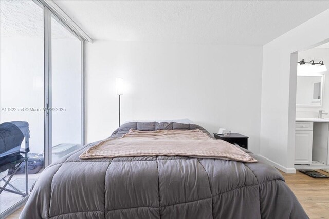 9481 Evergreen Pl Unit 206, Davie, FL 33324 - bedroom featuring light wood-type flooring and a textured ceiling
