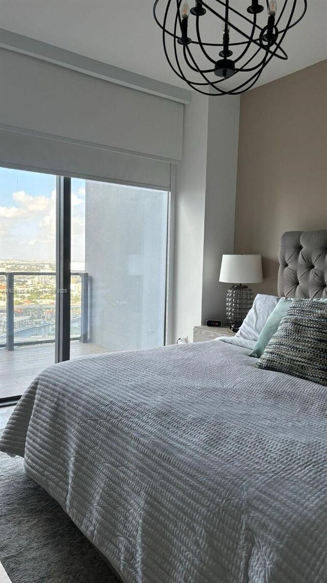 68 SE 6th St Unit 2804, Miami, FL 33131 - bedroom featuring a chandelier and access to exterior