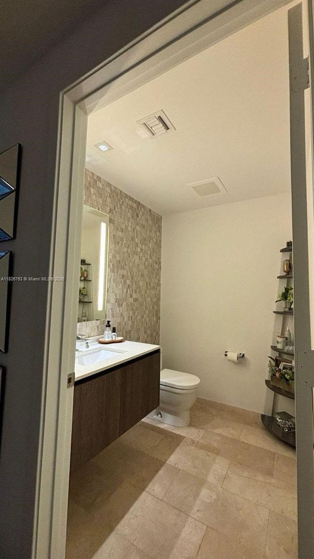 68 SE 6th St Unit 2804, Miami, FL 33131 - bathroom featuring vanity and stone finish floors