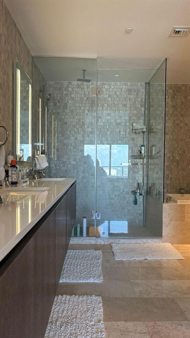 68 SE 6th St Unit 2804, Miami, FL 33131 - bathroom with a shower stall, vanity, a tub to relax in, and healthy amount of natural light