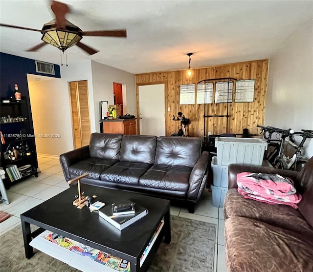 8325 SW 72nd Ave Unit 214C, Miami, FL 33143 - living area featuring wooden walls, a ceiling fan, and tile patterned flooring