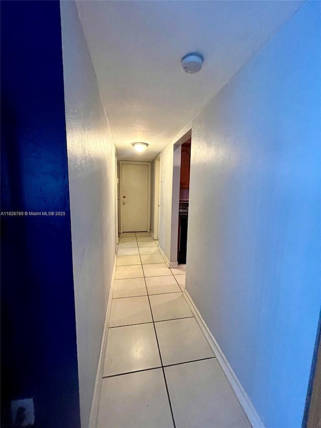 8325 SW 72nd Ave Unit 214C, Miami, FL 33143 - hallway featuring light tile patterned floors and baseboards