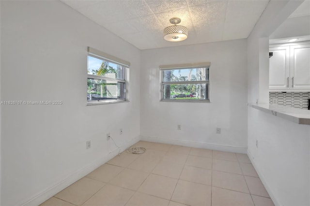 13800 SW 5th Ct Unit 101M, Pembroke Pines, FL 33027 - spare room featuring healthy amount of natural light and light tile patterned flooring