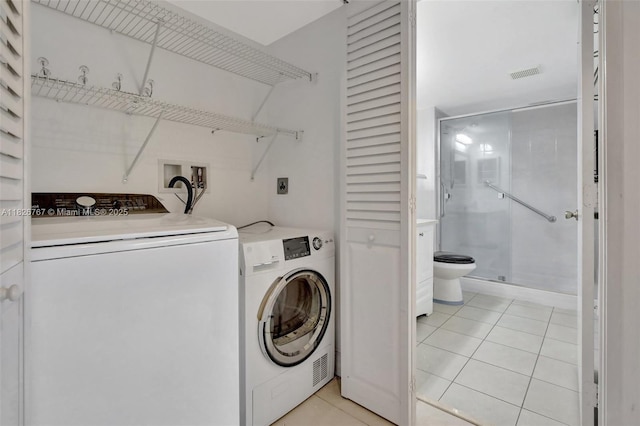 13800 SW 5th Ct Unit 101M, Pembroke Pines, FL 33027 - laundry room featuring light tile patterned floors and washer and dryer
