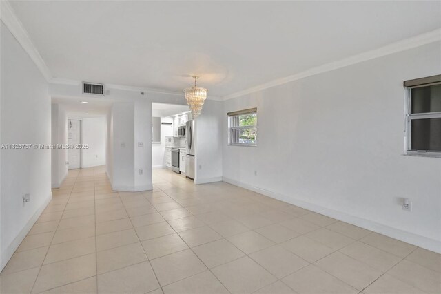 13800 SW 5th Ct Unit 101M, Pembroke Pines, FL 33027 - spare room featuring ornamental molding, a chandelier, and light tile patterned floors