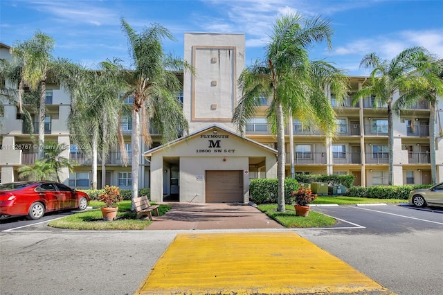 13800 SW 5th Ct Unit 101M, Pembroke Pines, FL 33027 - view of property featuring uncovered parking