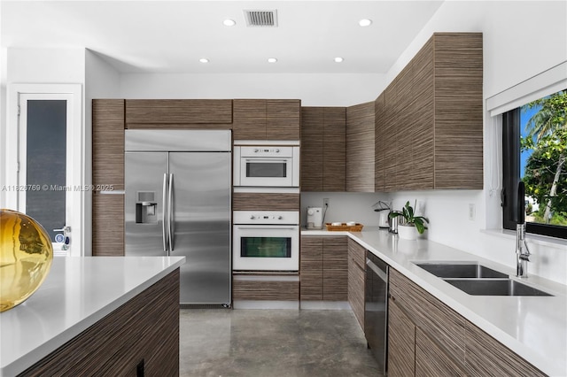 1009 NE 104th St, Miami Shores, FL 33138 - kitchen with stainless steel appliances, finished concrete flooring, light countertops, modern cabinets, and recessed lighting