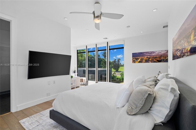 1009 NE 104th St, Miami Shores, FL 33138 - bedroom with recessed lighting, wood finished floors, expansive windows, and a ceiling fan