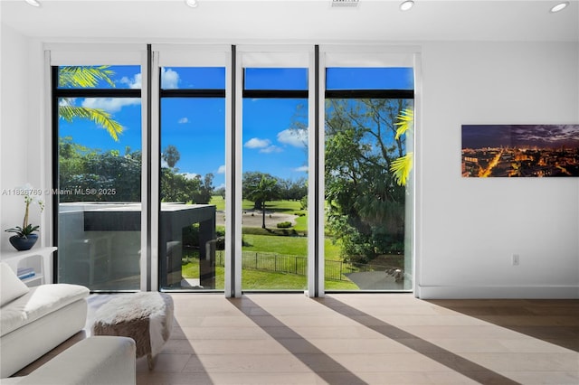 1009 NE 104th St, Miami Shores, FL 33138 - entryway featuring recessed lighting, a wall of windows, and wood finished floors