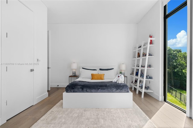 1009 NE 104th St, Miami Shores, FL 33138 - bedroom with wood finished floors and access to outside