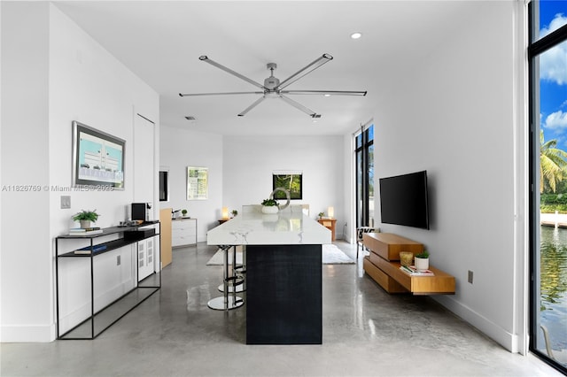1009 NE 104th St, Miami Shores, FL 33138 - living area featuring concrete floors, a ceiling fan, and recessed lighting