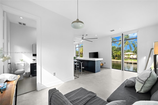 1009 NE 104th St, Miami Shores, FL 33138 - living room featuring finished concrete flooring and recessed lighting