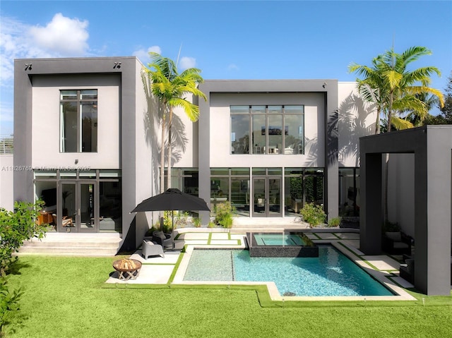 1009 NE 104th St, Miami Shores, FL 33138 - back of house featuring french doors, stucco siding, a lawn, a patio, and a pool with connected hot tub