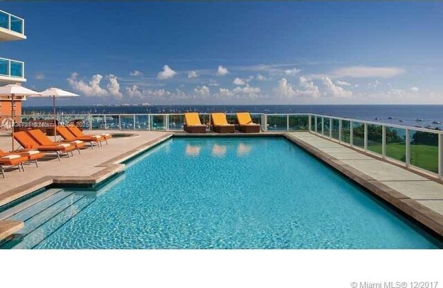 2889 Mcfarlane Rd Unit 1908, Miami, FL 33133 - community pool featuring a patio area and a water view
