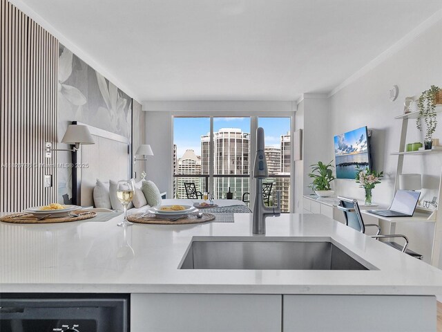 2889 Mcfarlane Rd Unit 1908, Miami, FL 33133 - kitchen featuring crown molding, light countertops, a desk, and dishwasher