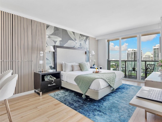 2889 Mcfarlane Rd Unit 1908, Miami, FL 33133 - bedroom featuring access to exterior, wood finished floors, and a city view
