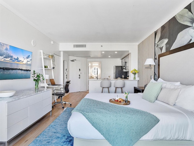 2889 Mcfarlane Rd Unit 1908, Miami, FL 33133 - bedroom with freestanding refrigerator and light wood finished floors