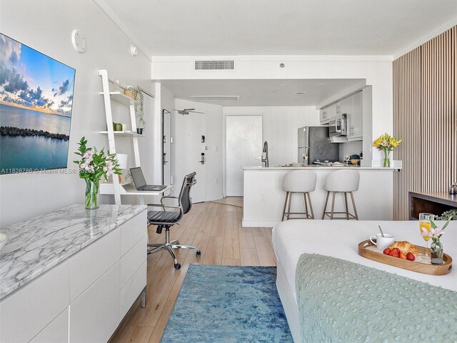 2889 Mcfarlane Rd Unit 1908, Miami, FL 33133 - bedroom featuring light wood finished floors, freestanding refrigerator, and a desk