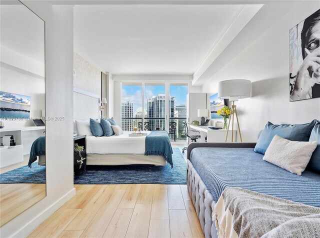 2889 Mcfarlane Rd Unit 1908, Miami, FL 33133 - bedroom featuring wood finished floors, access to outside, and a view of city