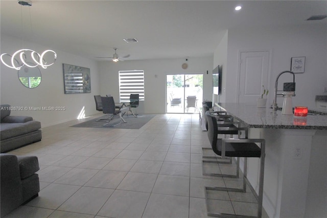 2574 SW Cameo Blvd, Port St Lucie, FL 34953 - living room with a ceiling fan, light tile patterned floors, and recessed lighting