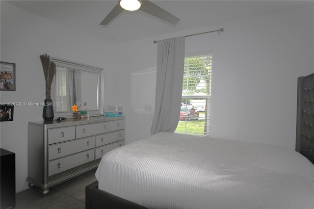 2574 SW Cameo Blvd, Port St Lucie, FL 34953 - bedroom with dark tile patterned flooring and ceiling fan