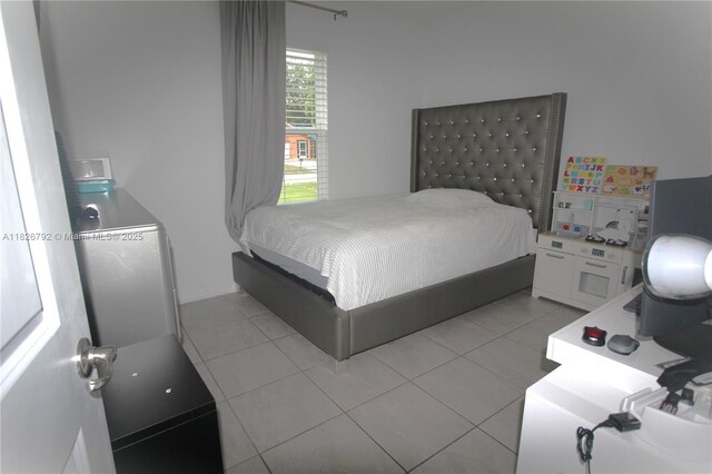 2574 SW Cameo Blvd, Port St Lucie, FL 34953 - bedroom with light tile patterned flooring