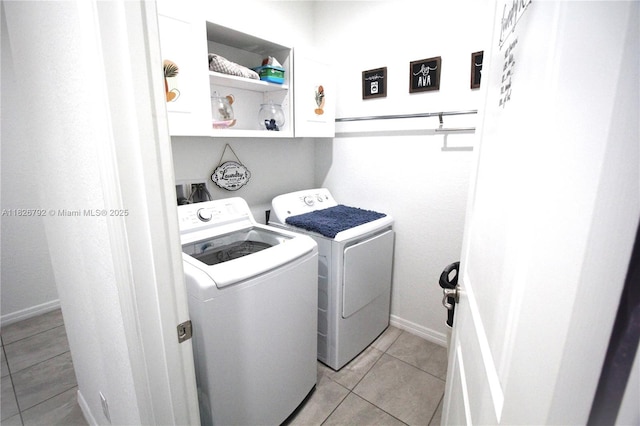 2574 SW Cameo Blvd, Port St Lucie, FL 34953 - washroom featuring cabinet space, washer and dryer, and light tile patterned flooring