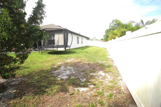2574 SW Cameo Blvd, Port St Lucie, FL 34953 - fenced backyard with a trampoline