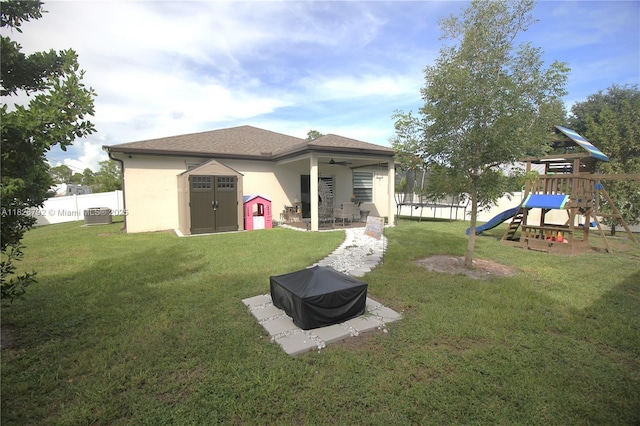 2574 SW Cameo Blvd, Port St Lucie, FL 34953 - rear view of property with stucco siding, a playground, ceiling fan, and a patio