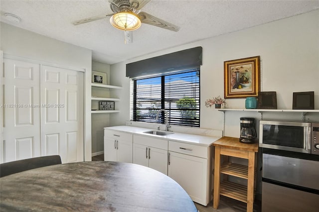 10030 SW 8th St, Pembroke Pines, FL 33025 - kitchen featuring stainless steel microwave, a textured ceiling, ceiling fan, white cabinetry, and open shelves