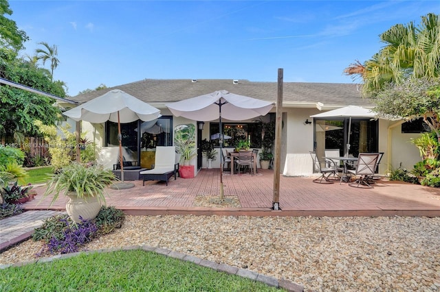 10030 SW 8th St, Pembroke Pines, FL 33025 - rear view of house featuring a wooden deck, stucco siding, and outdoor dining space