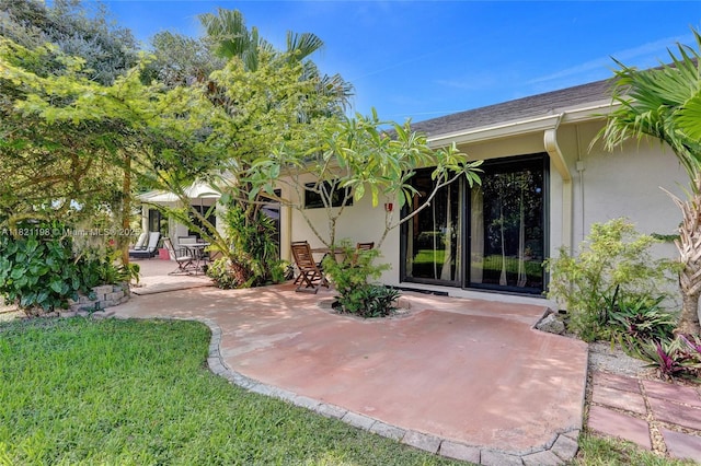 10030 SW 8th St, Pembroke Pines, FL 33025 - rear view of house with a patio, stucco siding, and a lawn