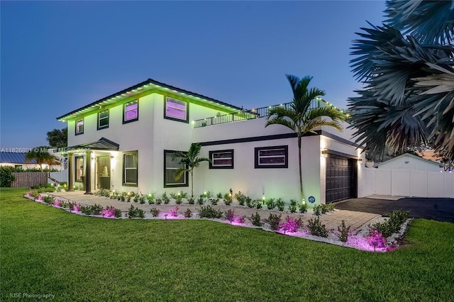 12220 Tara Dr, Plantation, FL 33325 - back of property featuring stucco siding, a garage, driveway, and a balcony