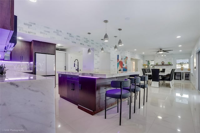 12220 Tara Dr, Plantation, FL 33325 - kitchen featuring freestanding refrigerator, light tile patterned floors, ceiling fan, pendant lighting, and wallpapered walls
