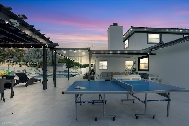 12220 Tara Dr, Plantation, FL 33325 - patio terrace at dusk featuring an outdoor hangout area, an outdoor pool, and a patio