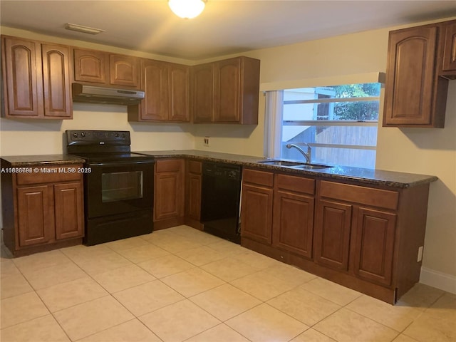 1624 NE 48th Ct, Pompano Beach, FL 33064 - kitchen with black appliances, under cabinet range hood, and light tile patterned flooring