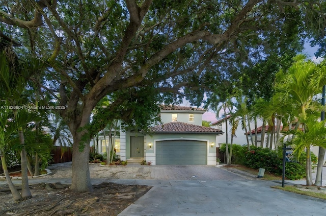 6425 SW 164th Ave, Miami, FL 33193 - mediterranean / spanish-style house with a tile roof, concrete driveway, an attached garage, and stucco siding