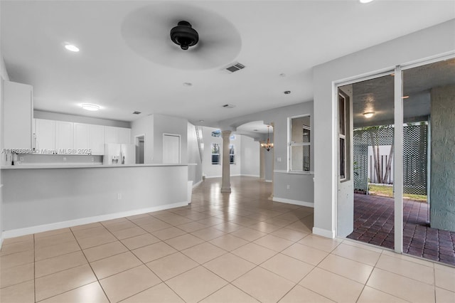 6425 SW 164th Ave, Miami, FL 33193 - unfurnished living room with ornate columns, light tile patterned floors, recessed lighting, arched walkways, and healthy amount of natural light
