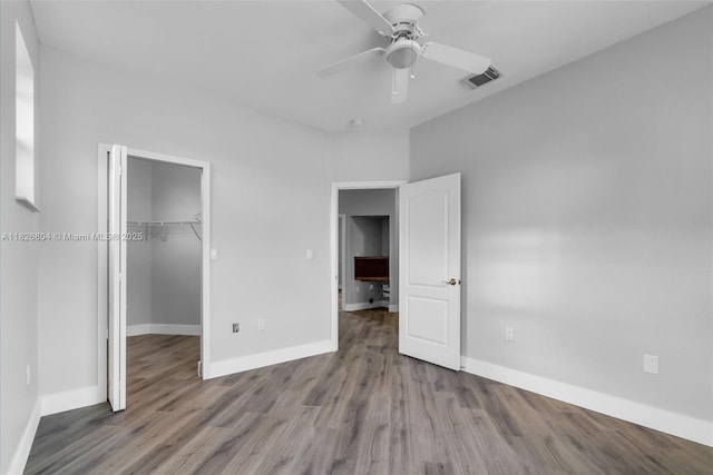 6425 SW 164th Ave, Miami, FL 33193 - unfurnished bedroom with wood finished floors, a walk in closet, a closet, and a ceiling fan