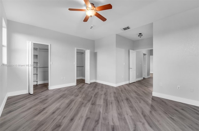 6425 SW 164th Ave, Miami, FL 33193 - unfurnished bedroom featuring wood finished floors, multiple closets, and a ceiling fan