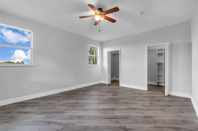 6425 SW 164th Ave, Miami, FL 33193 - unfurnished bedroom with multiple closets, wood finished floors, and a ceiling fan